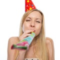 Young woman blowing into party horn blower Royalty Free Stock Photo