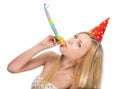 Young woman blowing into party horn blower Royalty Free Stock Photo