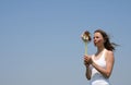 Young woman blowing a pinwheel Royalty Free Stock Photo