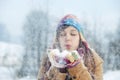 Young woman blowing snow to away Royalty Free Stock Photo