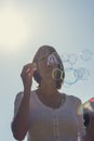 Young woman blowing soap bubbles Royalty Free Stock Photo