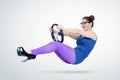 Young woman in blue dress and glasses with a car steering wheel. Lady driver concept