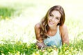 Young woman in blue dress lying on grass