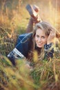 Young woman with blue eyes in autumn meadow Royalty Free Stock Photo