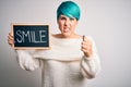 Young woman with blue fashion hair holding blackboard with smile message annoyed and frustrated shouting with anger, crazy and
