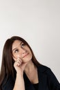 Young woman in blue full of doubts and hesitation. Looking up