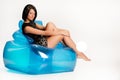 Young Woman On A Blue Inflatable Armchair