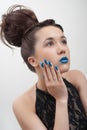 Young woman with blue lips and nails