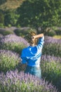 Young woman in blue shirt enjoying lavender field, Isparta, Turkey