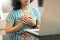 Young woman in blue shirt with sincere smile showing grateful gesture with touching on her chest with hands. Asian girl feeling Royalty Free Stock Photo