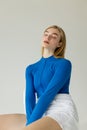 young woman in blue zipped turtleneck