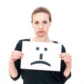 Young woman with board sad emoticon face sign