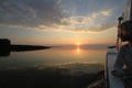 Young woman boating at sunset on the Danube Delta