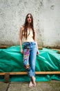 Young woman in boho style blue jeans with colorful applications