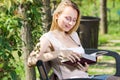 Young woman with book in garden Royalty Free Stock Photo
