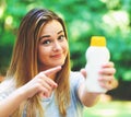 Young woman a bottle of sunblock outside Royalty Free Stock Photo