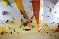 Young woman bouldering in climbing gym