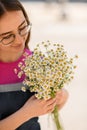 young woman with bouquet of fresh white small daisies in her hands Royalty Free Stock Photo