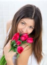 Young woman with bouquet of red tulips flowers