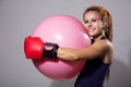 Young woman boxer with big rubber ball