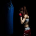 Young woman boxing on a punching bag Royalty Free Stock Photo
