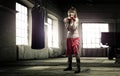 Young woman boxing workout in an old building