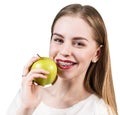 Young woman with brackets on teeth eating apple Royalty Free Stock Photo