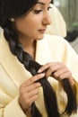 Young woman braiding hair. Royalty Free Stock Photo