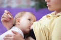 Young woman breast-feeding a baby, and measure its temperature