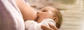 Young woman breast feeding her baby at home, closeup. Banner design Royalty Free Stock Photo