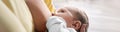 Young woman breast feeding her little baby, closeup. Banner design Royalty Free Stock Photo