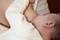 Young woman breastfeeding her baby at home close up Royalty Free Stock Photo