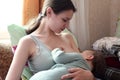 Young woman breastfeeding her baby at home. Milk from mother& x27;s breast is a natural medicine to baby. Mother day Royalty Free Stock Photo