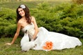 Young woman bride smiling and holding cute rabbit over park summ