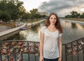 Young woman on bridge with love locks on fence Royalty Free Stock Photo