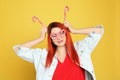 Young woman with bright dyed hair holding candy canes on yellow background Royalty Free Stock Photo