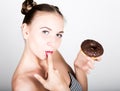 Young woman in bright makeup eating a tasty donut with icing. Funny joyful woman with sweets, dessert. dieting concept Royalty Free Stock Photo