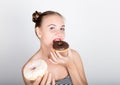 Young woman in bright makeup eating a tasty donut with icing. Funny joyful woman with sweets, dessert. dieting concept Royalty Free Stock Photo