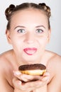 Young woman in bright makeup eating a tasty donut with icing. Funny joyful woman with sweets, dessert. dieting concept Royalty Free Stock Photo