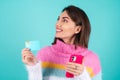 Young woman in a bright multicolored sweater on a blue background Royalty Free Stock Photo