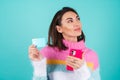 Young woman in a bright multicolored sweater on a blue background Royalty Free Stock Photo