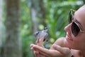 Young woman bringing newborn turtle in the fingers