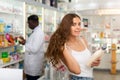 Young woman electing haircare shampoo