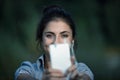 Selfie-taking woman, white phone, wired earphones, park Royalty Free Stock Photo