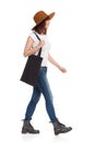 Young Woman In Brown Hat Is Walking With Black Bag On Her Shoulder Royalty Free Stock Photo