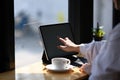 Close up view of young woman hand pointing on screen of tablet computer . Royalty Free Stock Photo