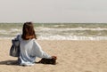 Young woman brunette in a light blue cardigan and jeans, with Royalty Free Stock Photo