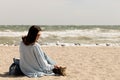 Young woman brunette in a light blue cardigan and jeans, with Royalty Free Stock Photo