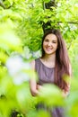 Young woman the brunette in the spring blossoming garden