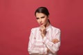 Young woman brunette thinking on red banner background Royalty Free Stock Photo